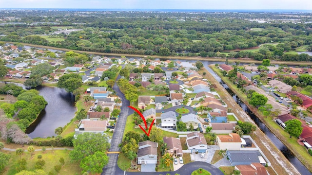 bird's eye view featuring a water view and a residential view