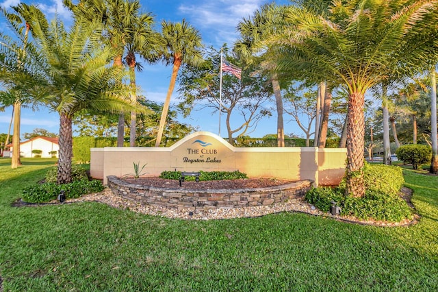 community sign featuring a lawn