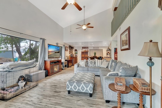 living area with lofted ceiling and wood finished floors