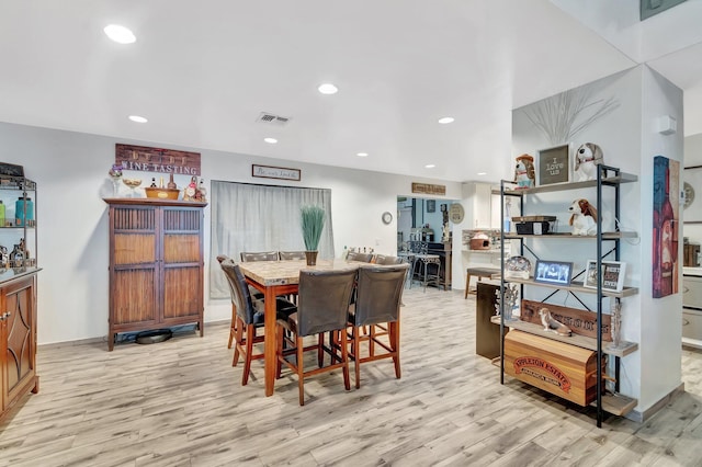 dining area with recessed lighting, visible vents, and light wood-style flooring