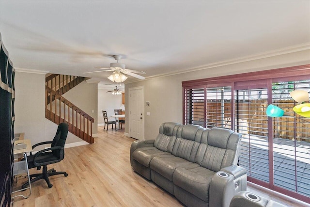 living room featuring ceiling fan, wood finished floors, baseboards, and ornamental molding