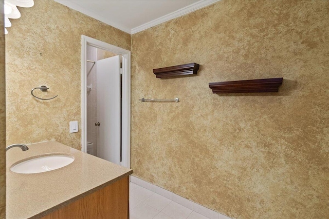 bathroom featuring tile patterned floors, toilet, vanity, and ornamental molding