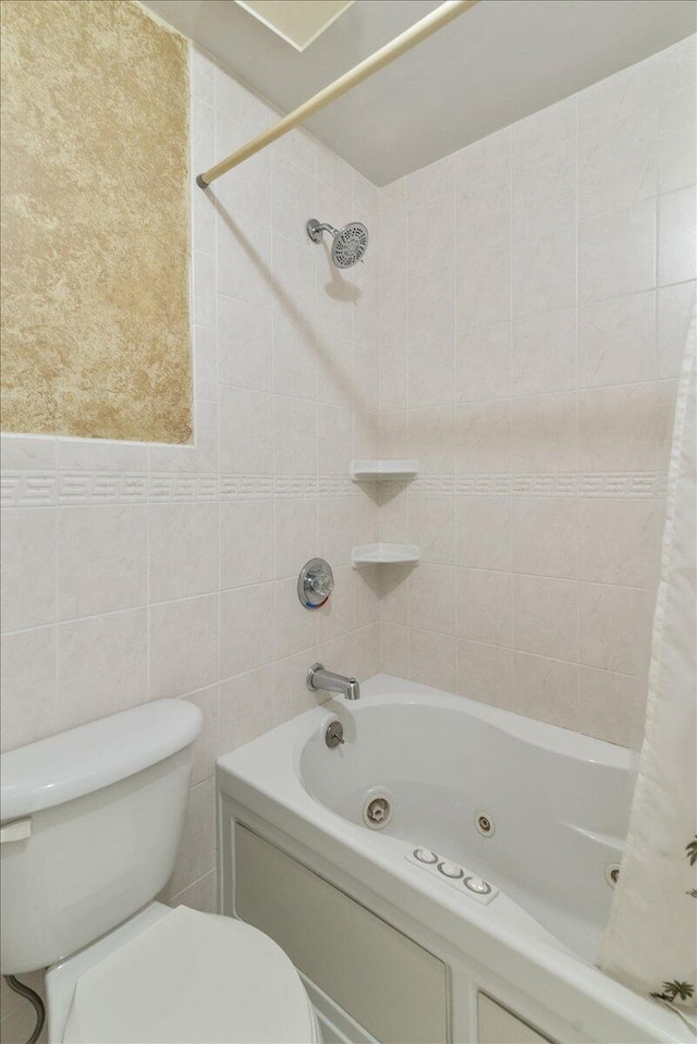 full bathroom with toilet, tile walls, and a combined bath / shower with jetted tub