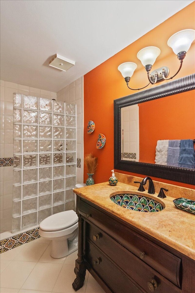 full bathroom with vanity, tile patterned floors, toilet, and a walk in shower