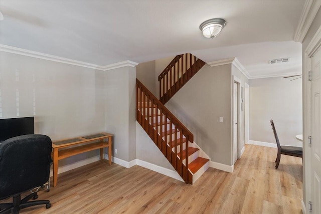 office area featuring ornamental molding, baseboards, visible vents, and light wood-type flooring