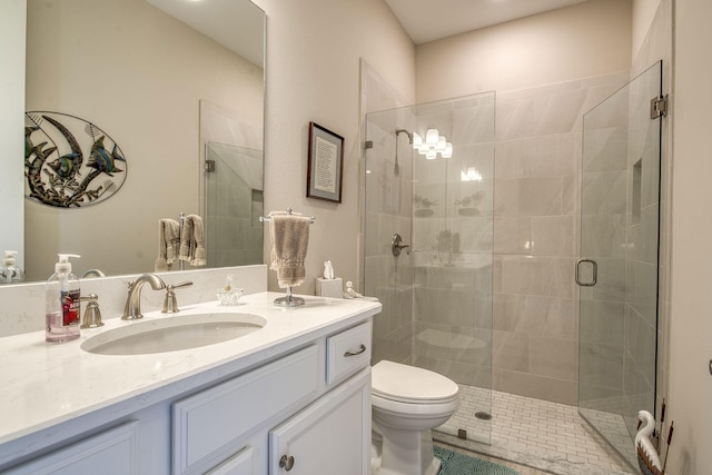 full bathroom featuring vanity, toilet, and a shower stall