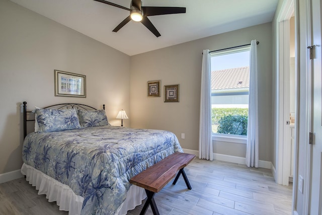 bedroom with light wood-style flooring, baseboards, and ceiling fan