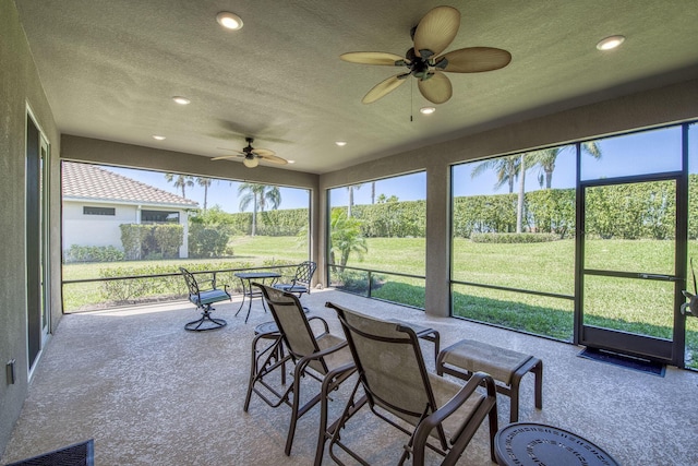 sunroom / solarium with visible vents and ceiling fan