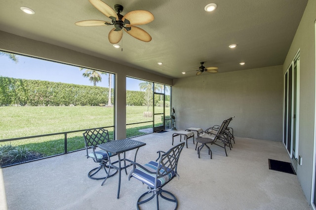 sunroom featuring a ceiling fan