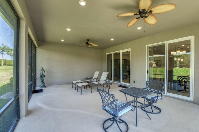 sunroom / solarium featuring ceiling fan