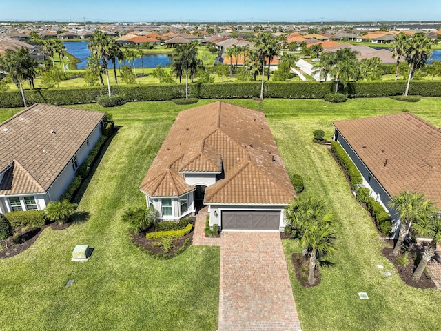 drone / aerial view with a water view and a residential view