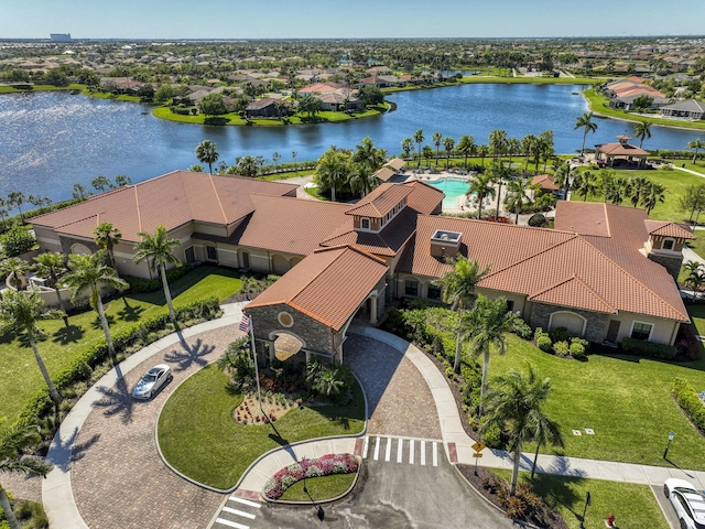 drone / aerial view with a residential view and a water view