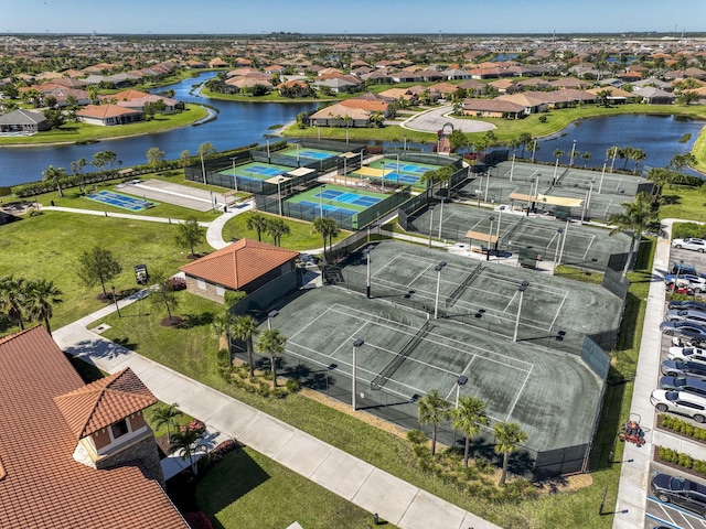 drone / aerial view featuring a residential view and a water view