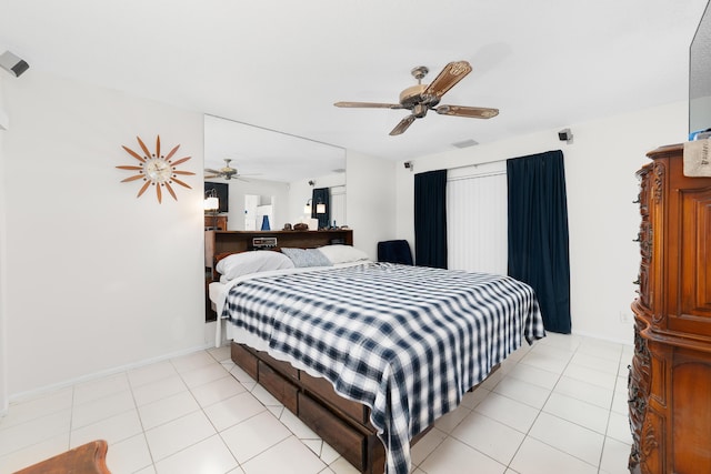 bedroom featuring light tile patterned floors, a ceiling fan, visible vents, and baseboards