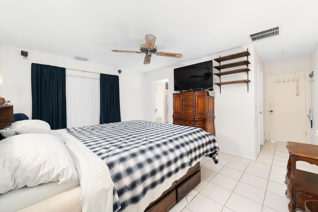 bedroom featuring light tile patterned flooring, visible vents, and a ceiling fan