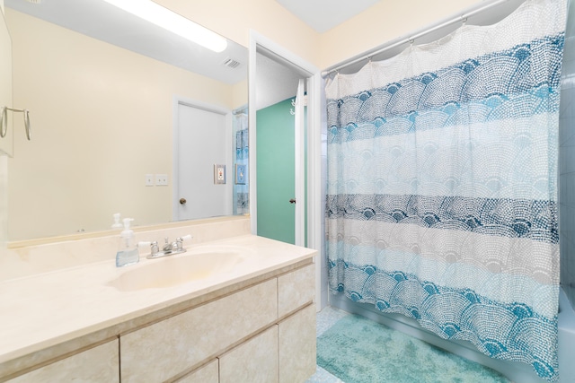 full bathroom with visible vents, shower / bath combo with shower curtain, and vanity