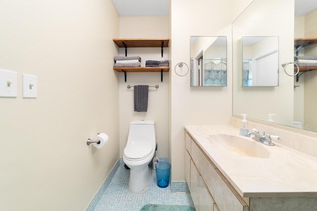 bathroom with tile patterned flooring, toilet, vanity, and baseboards