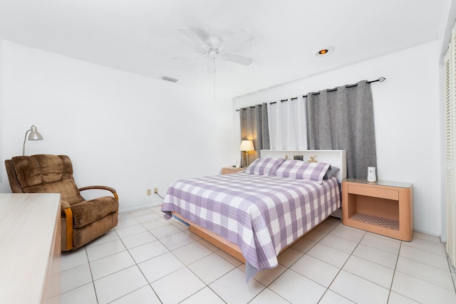 bedroom featuring ceiling fan, visible vents, baseboards, and light tile patterned flooring