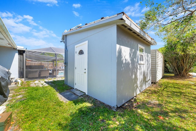 view of outdoor structure with an outbuilding and fence