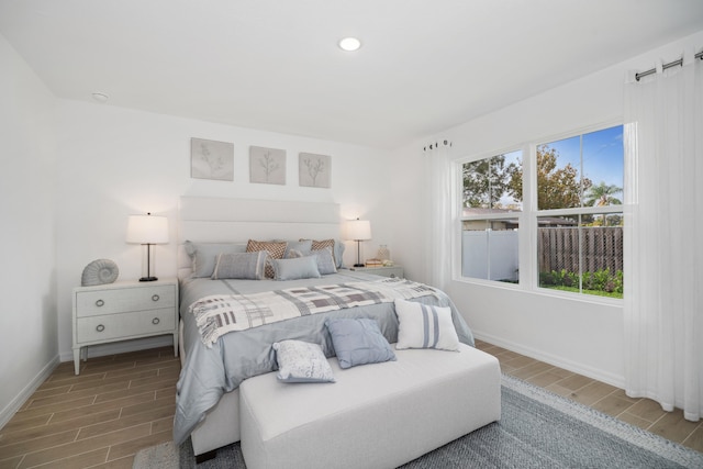 bedroom with recessed lighting, baseboards, and wood tiled floor