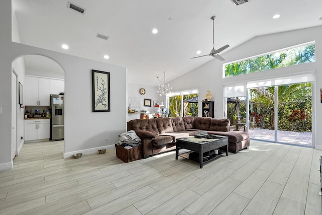 living room with arched walkways, visible vents, recessed lighting, and wood finish floors