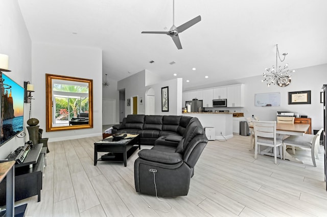 5822 Saddle Trail Ln, Lake Worth, FL 33449 - living area with a chandelier, a ceiling fan, light wood-type flooring, and high vaulted ceiling
