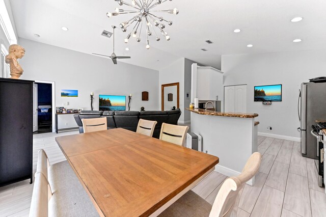 5822 Saddle Trail Ln, Lake Worth, FL 33449 - dining room featuring lofted ceiling, recessed lighting, a chandelier, and light wood finished floors