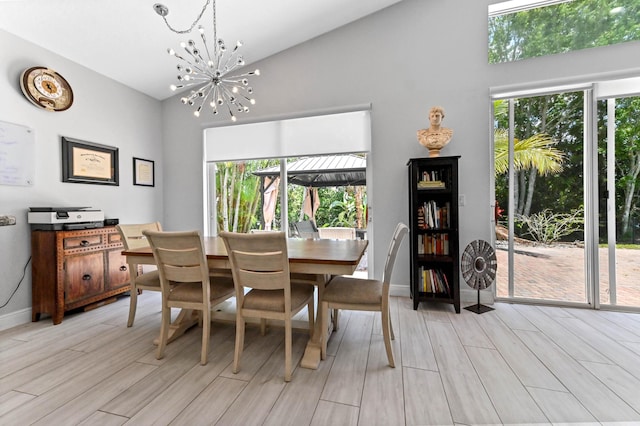 5822 Saddle Trail Ln, Lake Worth, FL 33449 - dining area featuring light wood-style flooring, high vaulted ceiling, a chandelier, and healthy amount of natural light