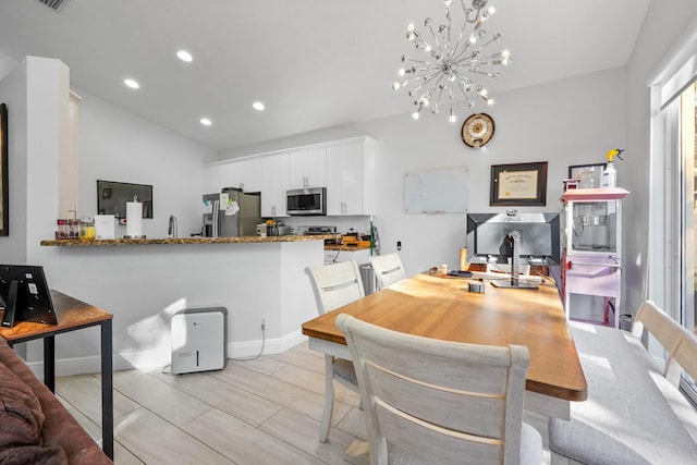 dining space featuring recessed lighting, baseboards, and a chandelier