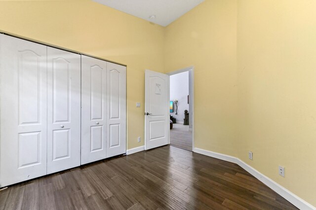5822 Saddle Trail Ln, Lake Worth, FL 33449 - unfurnished bedroom with dark wood-type flooring and a closet