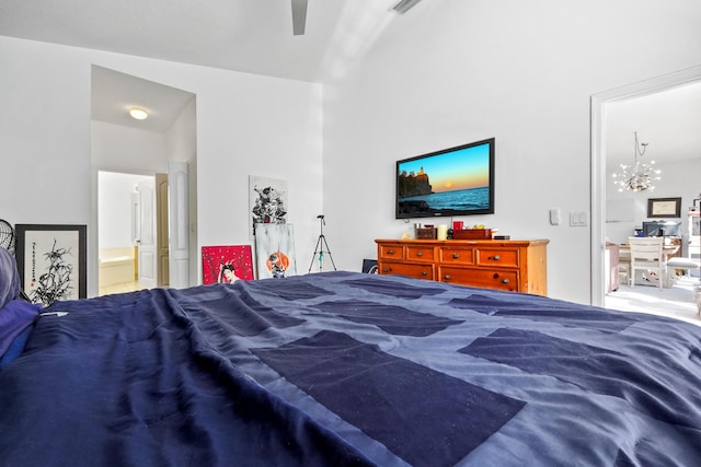 bedroom featuring ensuite bathroom and ceiling fan with notable chandelier