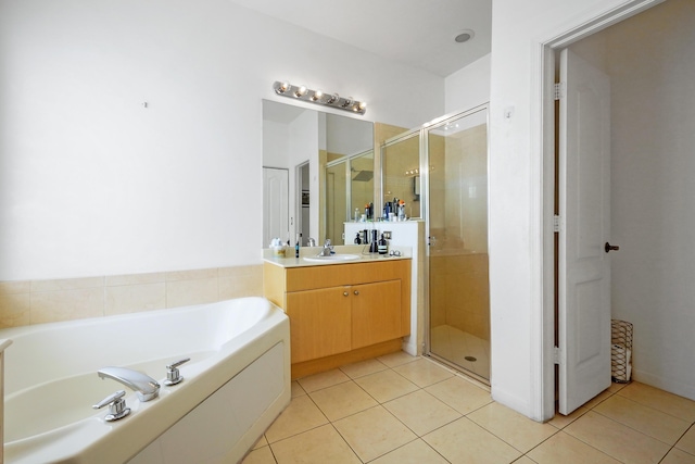 full bathroom featuring tile patterned flooring, a bath, vanity, and a stall shower