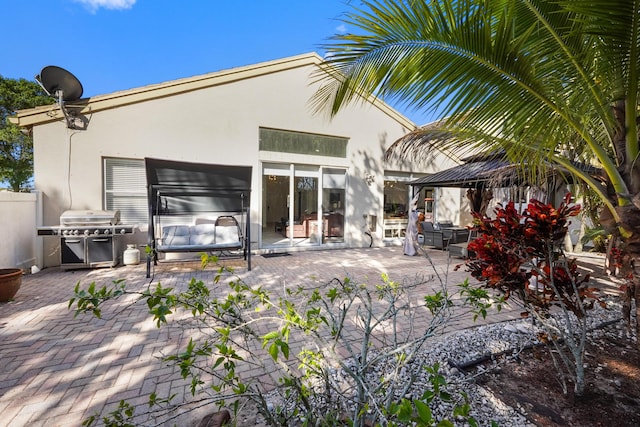 back of house with a gazebo, a patio area, and stucco siding