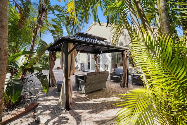 view of patio / terrace featuring a gazebo, an outdoor hangout area, and fence