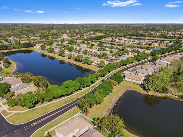 drone / aerial view with a water view and a residential view