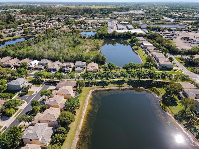 birds eye view of property with a water view and a residential view