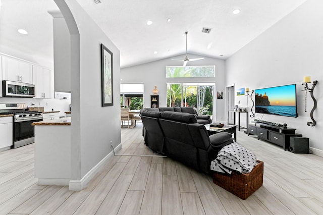 5822 Saddle Trail Ln, Lake Worth, FL 33449 - living room featuring arched walkways, lofted ceiling, light wood finished floors, a ceiling fan, and recessed lighting