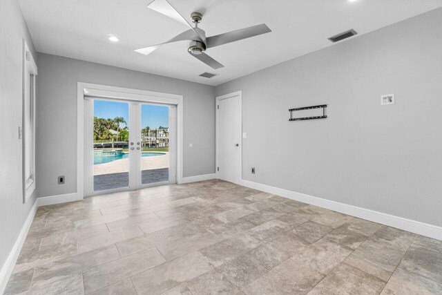 empty room featuring visible vents, baseboards, and ceiling fan