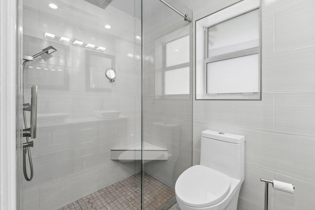 full bathroom with a shower stall and toilet