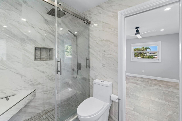 bathroom featuring a marble finish shower, toilet, and a ceiling fan