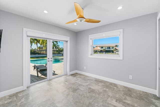 empty room with french doors, plenty of natural light, baseboards, and a ceiling fan