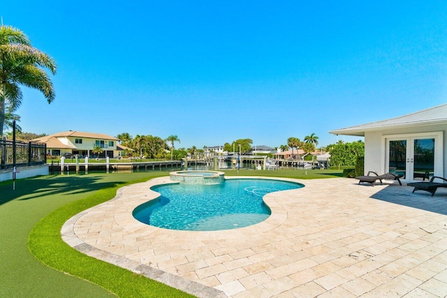 view of swimming pool featuring a patio area, french doors, and a pool with connected hot tub