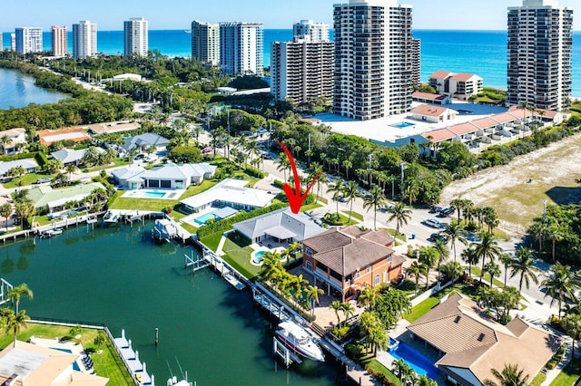 aerial view featuring a city view and a water view