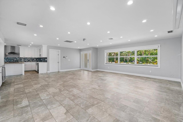 unfurnished living room with recessed lighting, visible vents, and baseboards