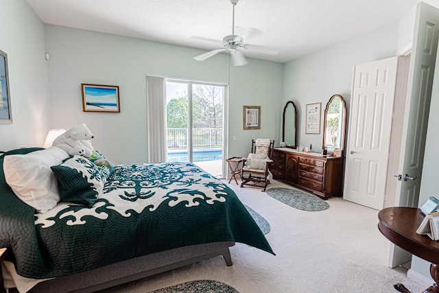 bedroom featuring light colored carpet, a textured ceiling, ceiling fan, and access to outside