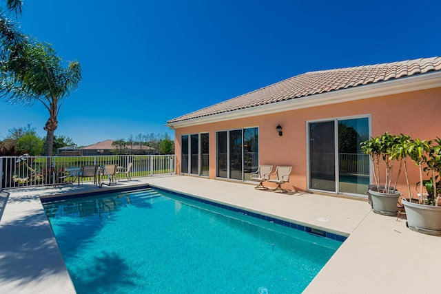 view of swimming pool with a fenced in pool, a patio area, and fence