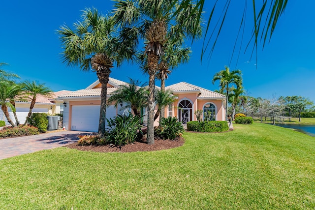 mediterranean / spanish home featuring decorative driveway, stucco siding, and a tiled roof