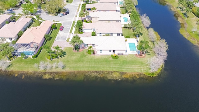 drone / aerial view with a water view and a residential view