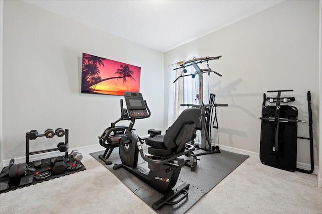 workout room with carpet and baseboards