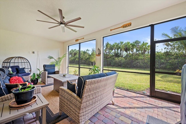 sunroom featuring a ceiling fan